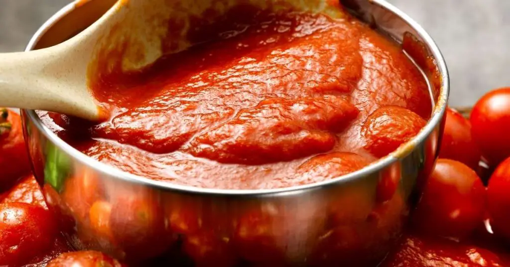 Tomato sauce simmering in a pan.