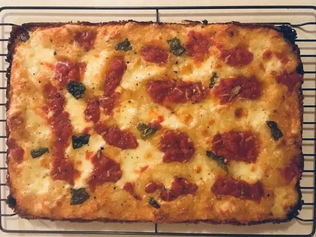 Why Your Pizza Crust Is So Soggy 1 Homemade Pan Pizza On Cooling Rack