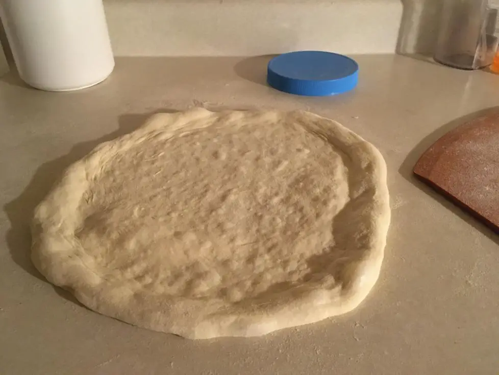 plain pizza dough uncooked on a counter