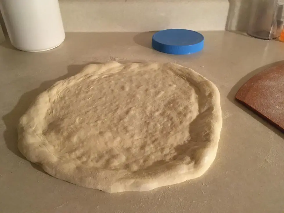 How To Make Neapolitan Pizza At Home - Step By Step Guide 2 plain pizza dough uncooked on a counter
