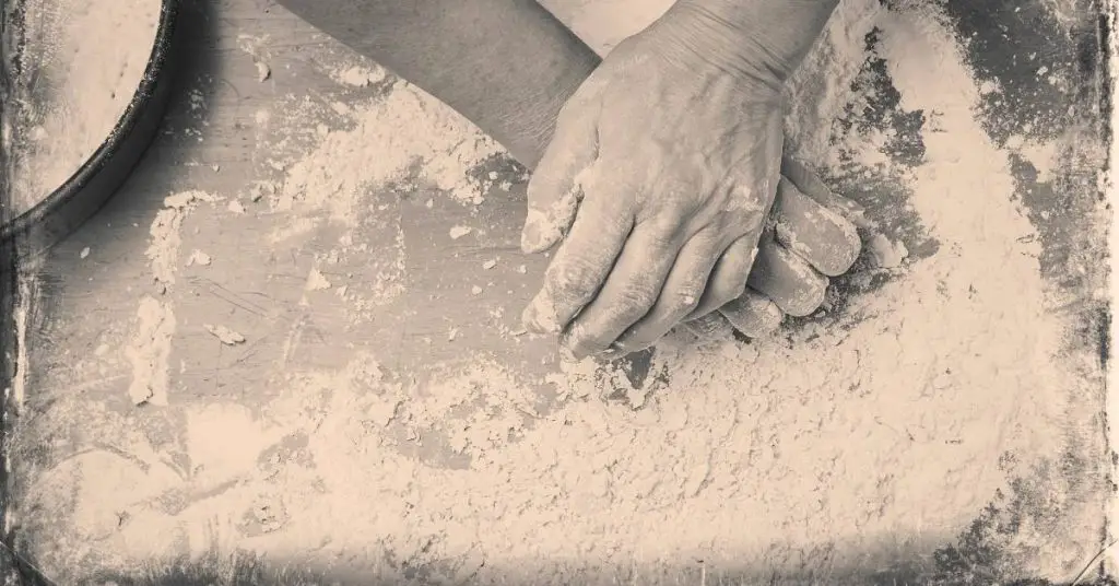 hands making pizza dough How Was Pizza Invented?