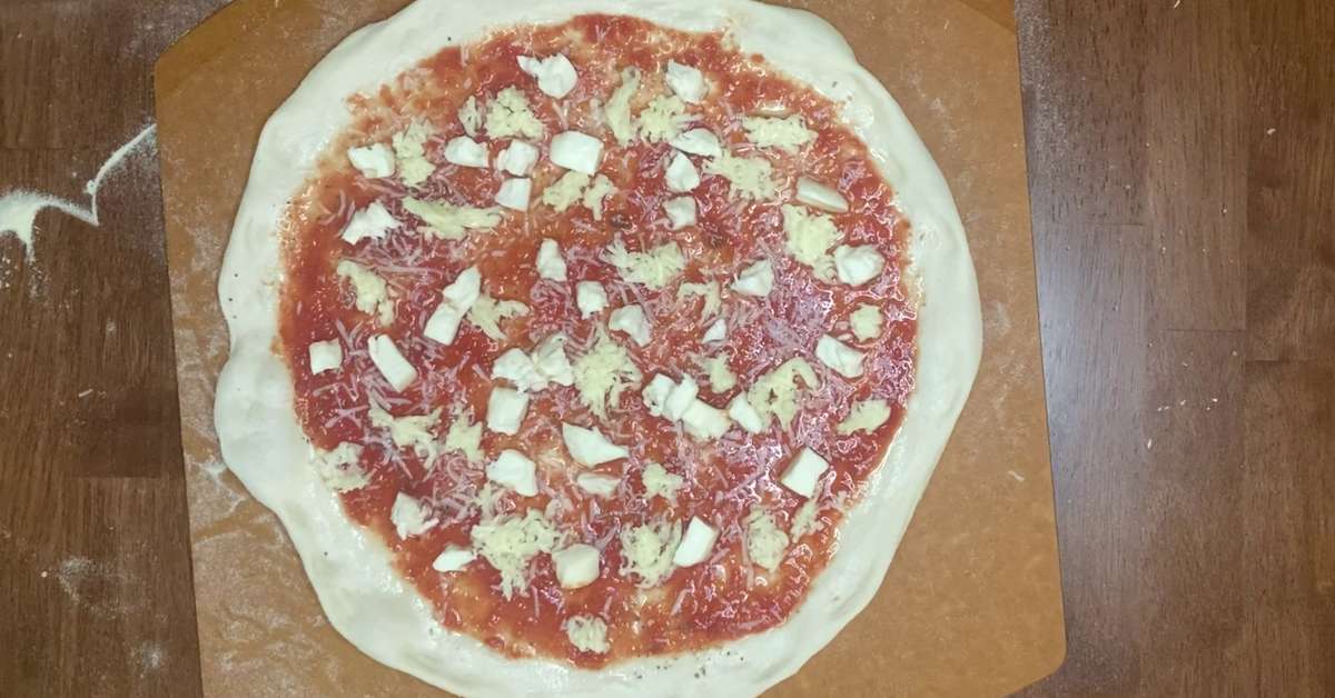 a homemade pizza about to go in the oven