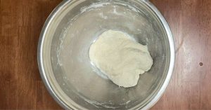 pizza dough in a mixing bowl