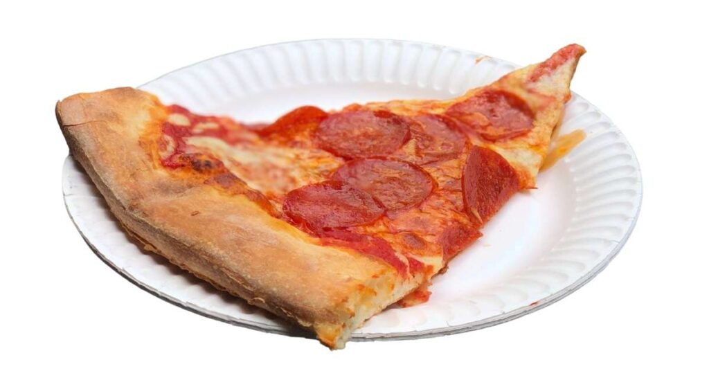 A slice of New York style pepperoni pizza on a plate.