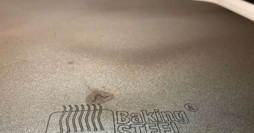 An Original Baking Steel sitting on the top of an oven after some mild use.