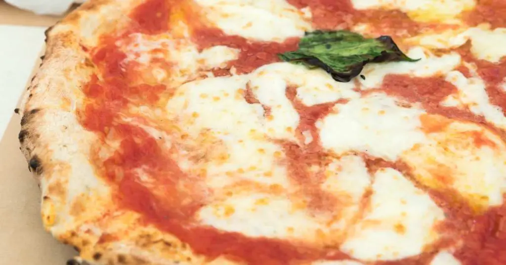 A Neapolitan pizza made with 00 flour is sitting on a plate.