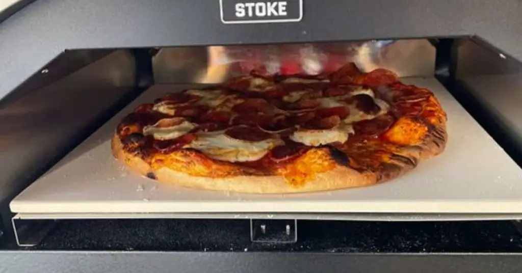 A pizza cooking inside the Stoke pizza oven.