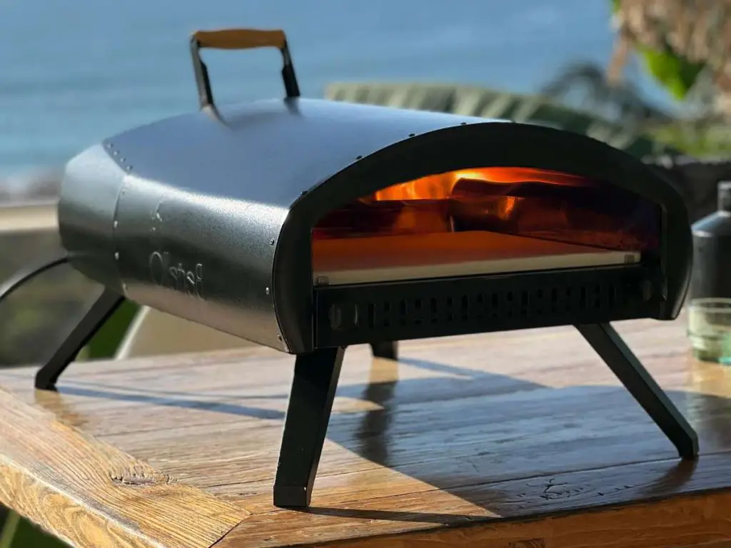 The Bertello Grande 16 pizza oven on a table outside.