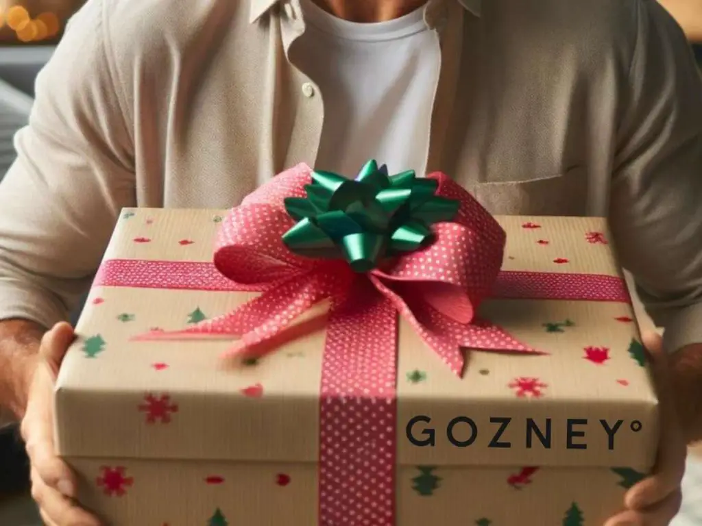 A man opening a holiday gift from Gozney.
