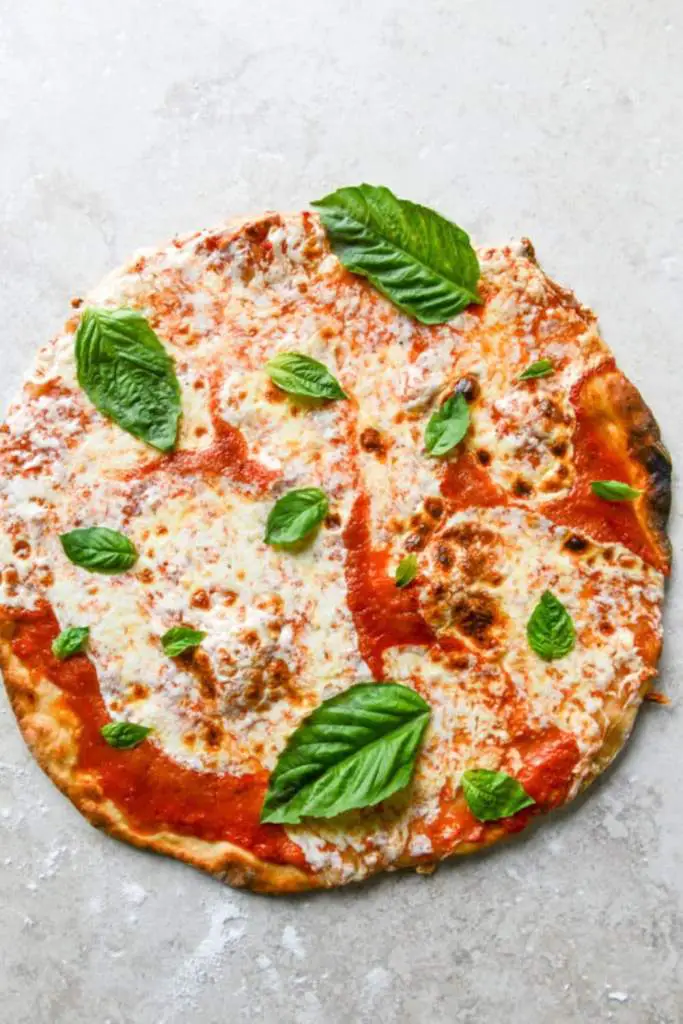10 Delicious Thin Crust Pizza Recipes You Have To Try 5 A margherita pizza with a crispy thin crust, topped with melted mozzarella, fresh tomato sauce, and basil leaves.