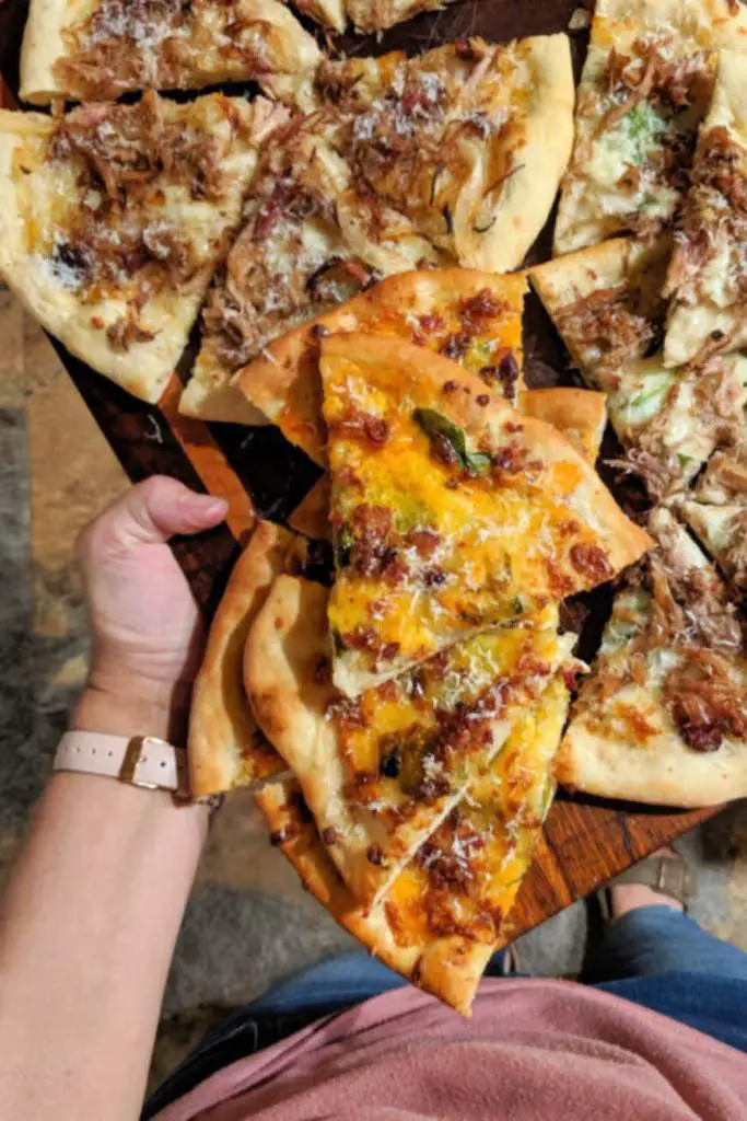 10 Delicious Thin Crust Pizza Recipes You Have To Try 8 A variety of artisan pizzas with different toppings served on a wooden board.