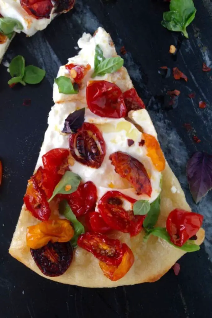 10 Delicious Thin Crust Pizza Recipes You Have To Try 9 A slice of pizza topped with roasted tomatoes, fresh basil, and creamy mozzarella.