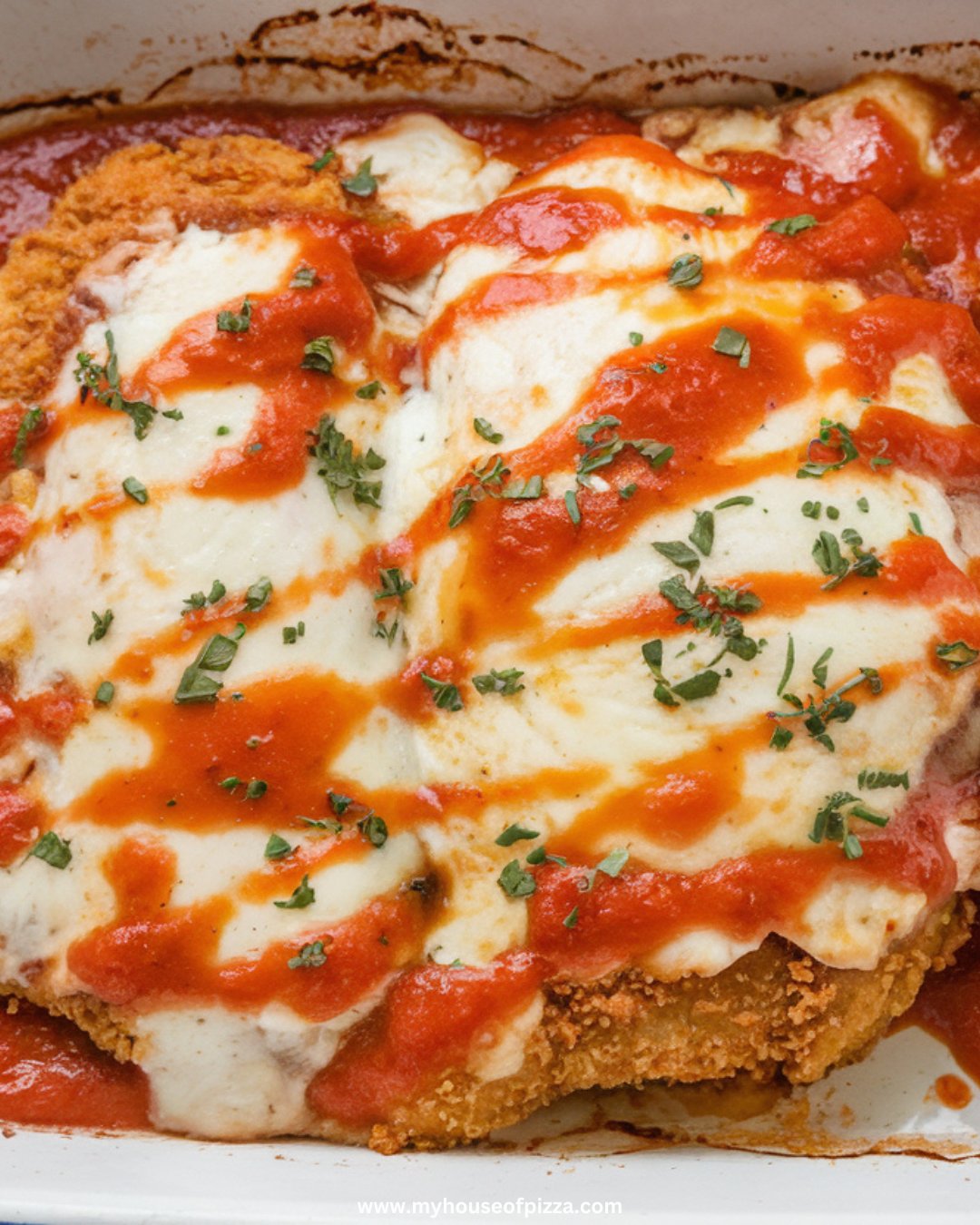 Crispy and Cheesy Chicken Parmesan Recipe for Easy Italian Nights 1 Photo taken from a top-down angle, using all-natural lighting, showing breaded chicken breasts frying in a skillet with bubbling olive oil, on a modern stainless steel gas stove.
