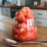 Refreshing watermelon granita served in a glass, topped with fluffy, vibrant pink shaved ice, perfect for summer cocktails like Prosecco Sangria. Ideal for enjoying as a frozen treat alongside easy sangria recipes or fruity slushies.